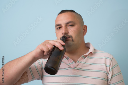 The man drinks beer