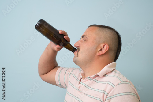 The man drinks beer