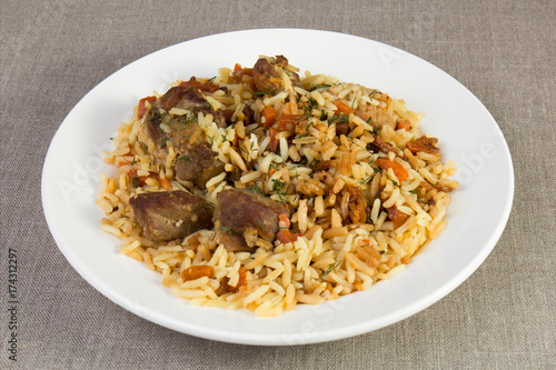 Pilaf - rice with meat and vegetables on the table