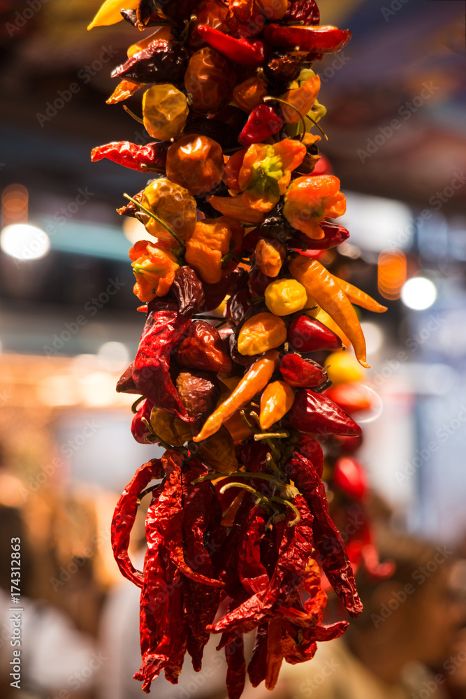 Dried chillies hanging  in market