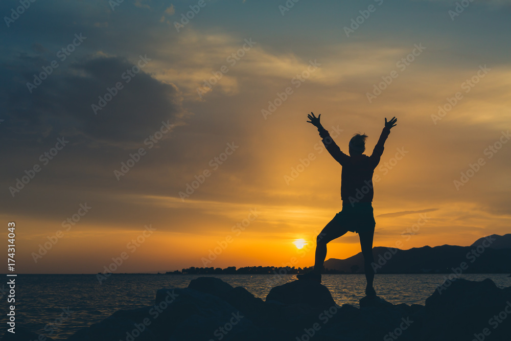 Girl hiker with arms outstretched enjoy beach and sea