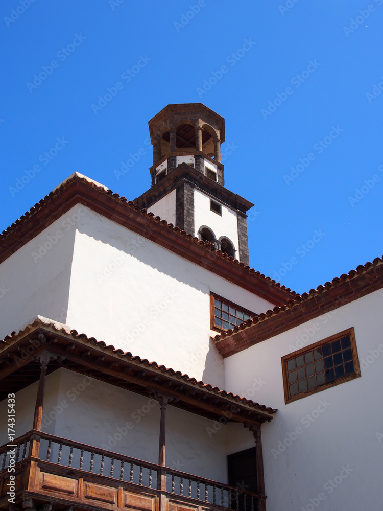 old white church in santa cruz tenerife with bell tower and blue sky