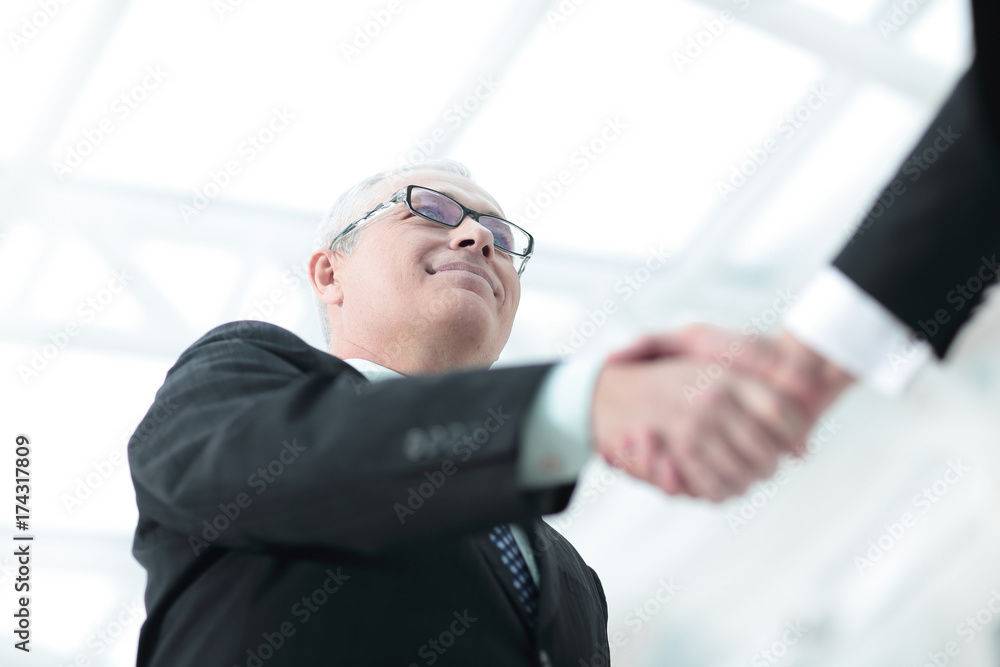 closeup of a business handshake partners. the image is blurred. closeup of a business handshake partners. the image is blurred.