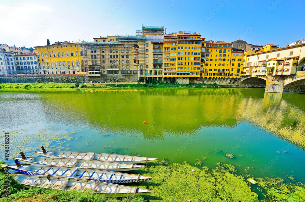 View of the Old Bridge across the Arno River in Florence on a sunny day
