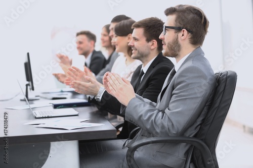 cheering business team sitting at Desk