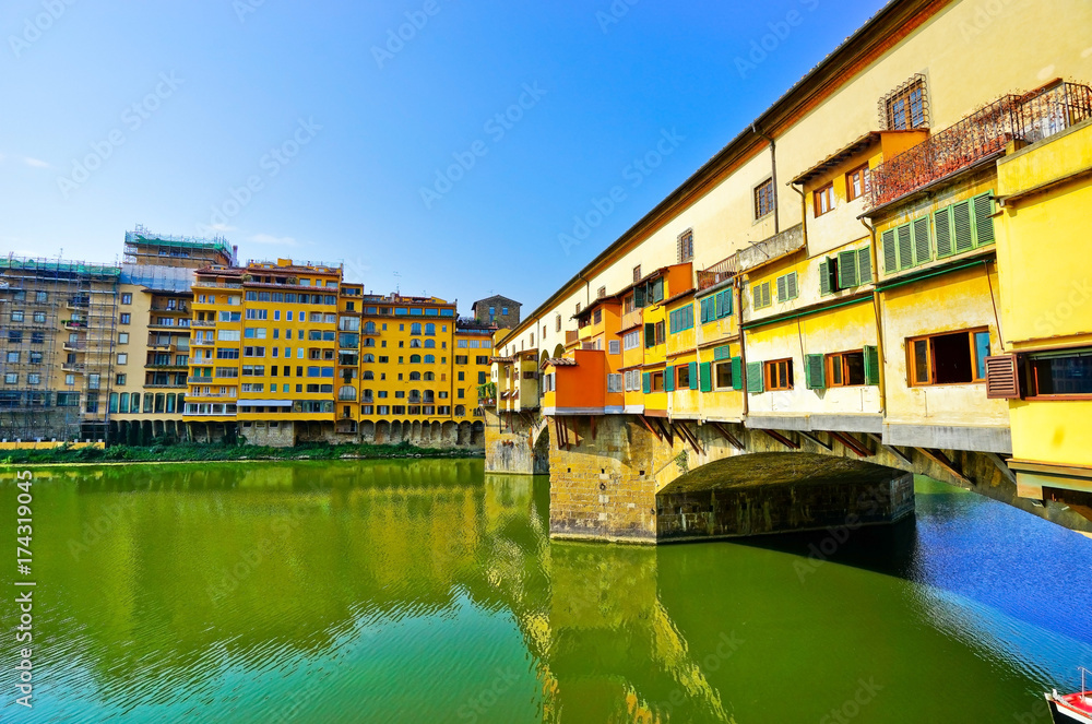 View of the Old Bridge across the Arno River in Florence on a sunny day