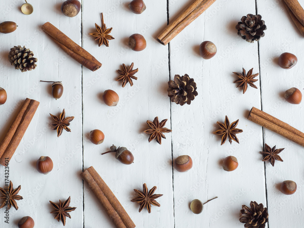 Cinnamon sticks spice star fir cones on white wooden background Flat lay Cinnamon sticks spice star fir cones on white wooden background Flat lay