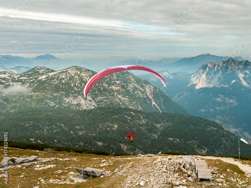 Paraglider starting from Krippenstein on a cloudy day