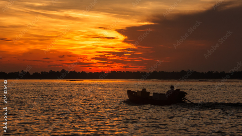 Boat Riding Silhouette on the morning sunrise in Hau River, a distributary of the Mekong river, Can Tho, Vietnam, Indochina, Asia.
