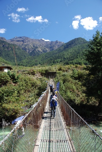 Trekking over a Bridge in Bhutan