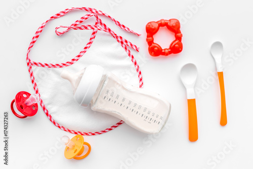 children feeding with breastmilk or infant formula powdered baby milk and toys on white background top view