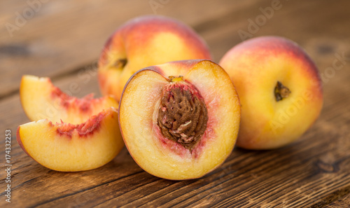 Portion of Fresh Peaches on wooden background, selective focus