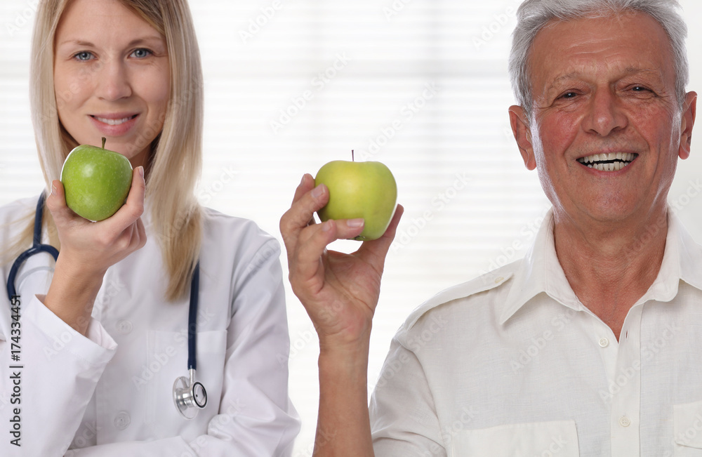 Female doctor and smiling patient holding an apple. Healthy eating and active senior lifestyle concept Female doctor and smiling patient holding an apple. Healthy eating and active senior lifestyle concept