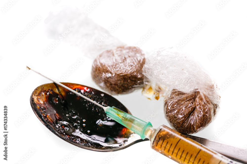 Two wraps of brown drugs, probably heroin, with a dirty spoon and a