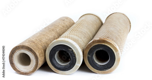 Dirty water filter cartridges on white background