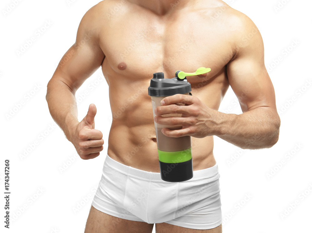 Naklejka premium Muscular man with protein shake on white background