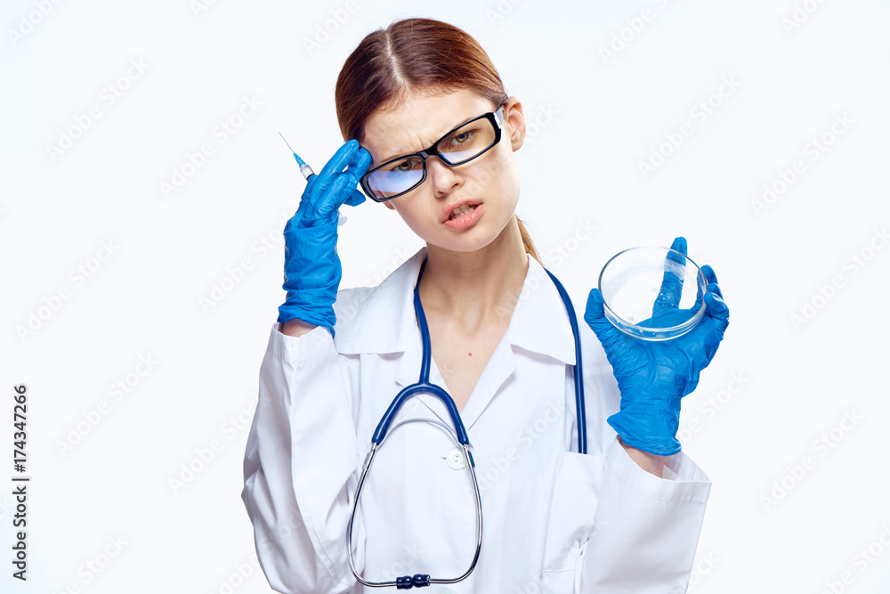woman scientist holding a petri dish and a syringe