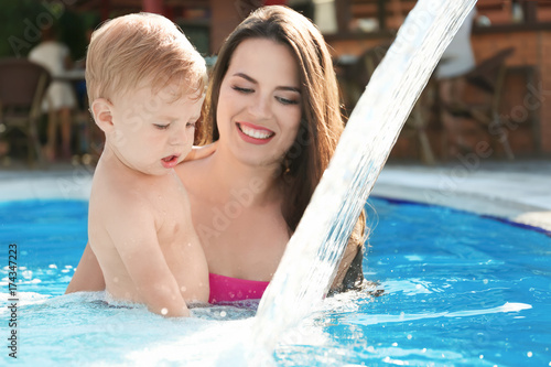 Baby with mother in swimming pool