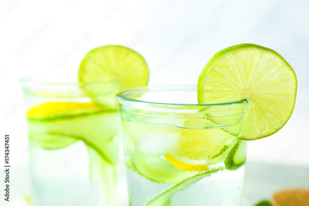 Delicious refreshing water with cucumber in glass, close up Delicious refreshing water with cucumber in glass, close up