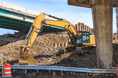 Fotografi Backhoe excavating construction site