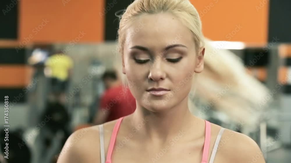 The girl is on the treadmill. Face closeup shot. The girl is on the treadmill. Face closeup shot.
