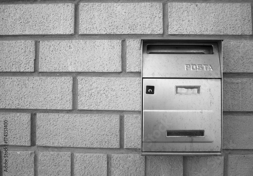 Iron mailbox on a brick wall (Pesaro, Italy)