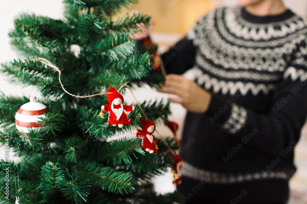 Woman decorating the Christmas tree Woman decorating the Christmas tree
