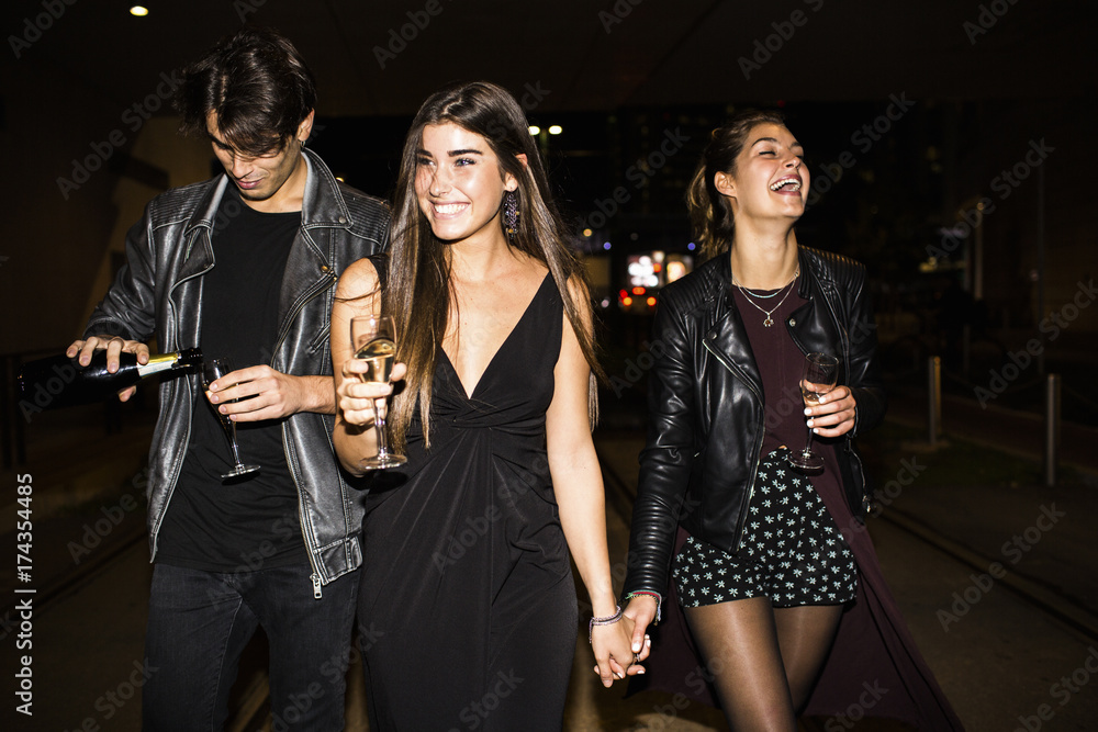 Happy friends go out in the street to celebrate Happy friends go out in the street to celebrate