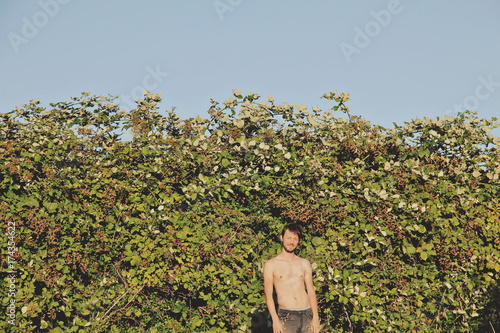 Young man and blackberry bramble