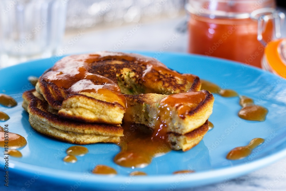 Close up on stack of homemade gluten free pancakes with peach jam Close up on stack of homemade gluten free pancakes with peach jam