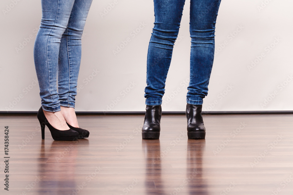 Female legs in denim pants heeled shoes Female legs in denim pants heeled shoes