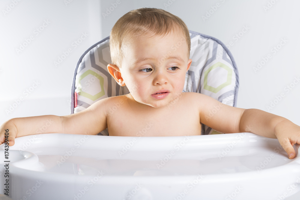 baby in the high chair. Kid waiting for favorite baby food baby in the high chair. Kid waiting for favorite baby food