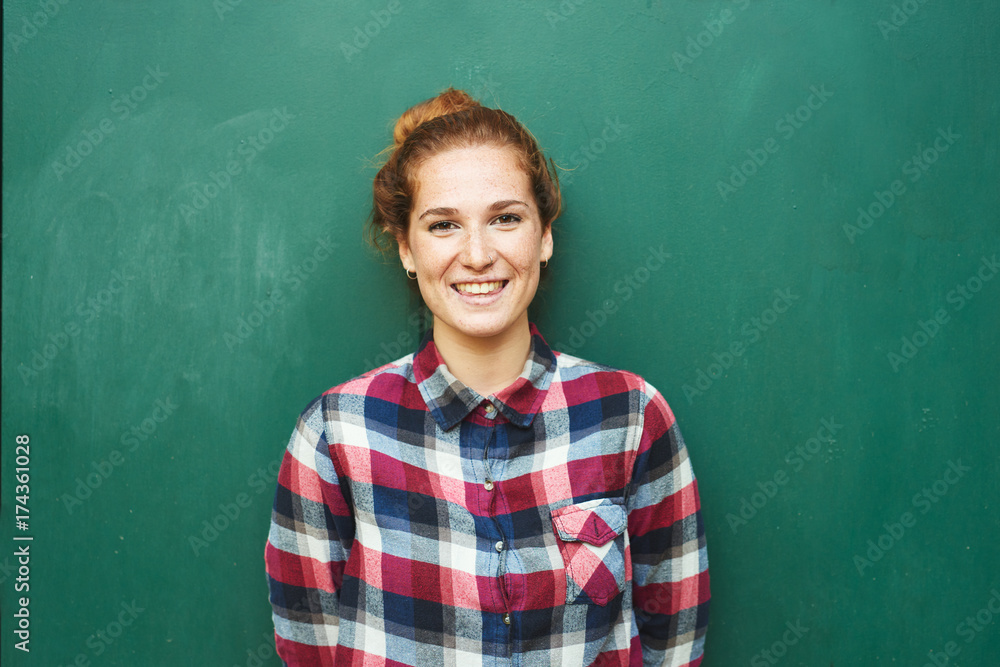 Portrait of red-haired woman smiling at camera Portrait of red-haired woman smiling at camera