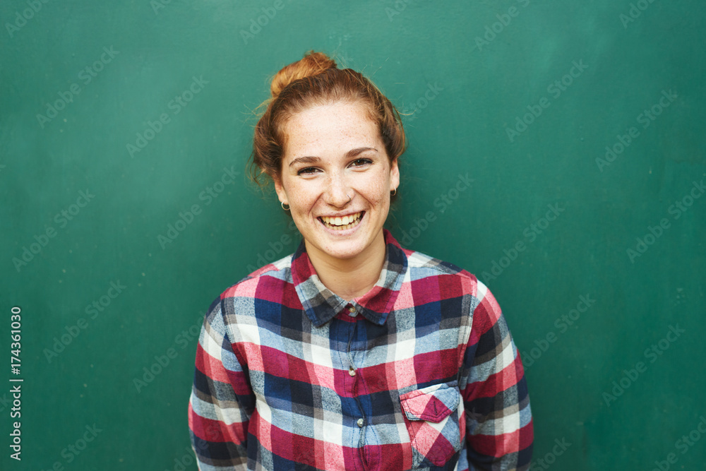 Portrait of red-haired woman smiling at camera Portrait of red-haired woman smiling at camera