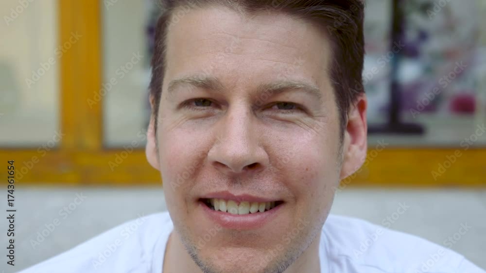 Close up of a man's face as he smiles, looks directly into the camera, and talks. Close up of a man's face as he smiles, looks directly into the camera, and talks.