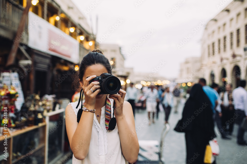 Female photographer taking photos on the street