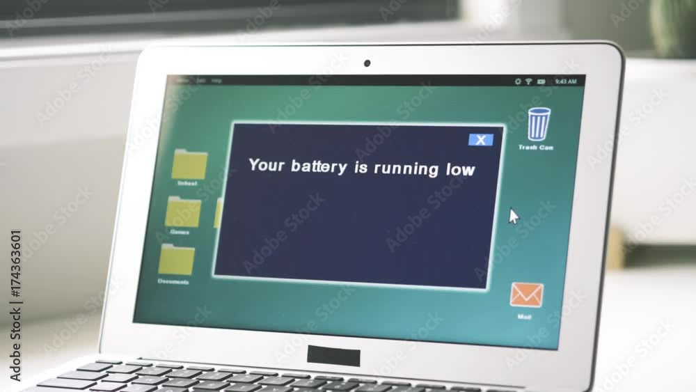 Laptop showing a warning message about low battery Laptop showing a warning message about low battery