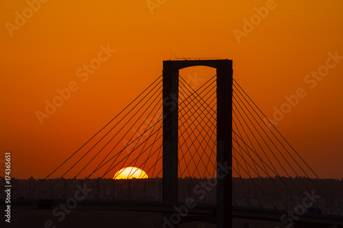 SEVILLE  SPAIN - AUGUST 21  2017  Fifth Centenary Bridge with partial eclipse sunset