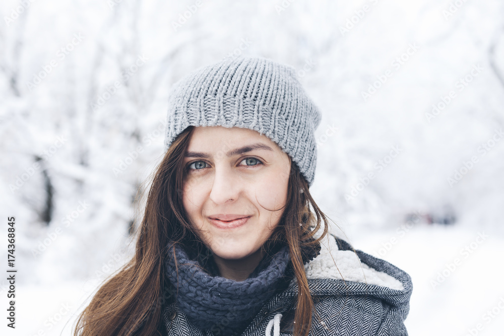 Portrait of happy woman wearing knit hat in snowy field Portrait of happy woman wearing knit hat in snowy field