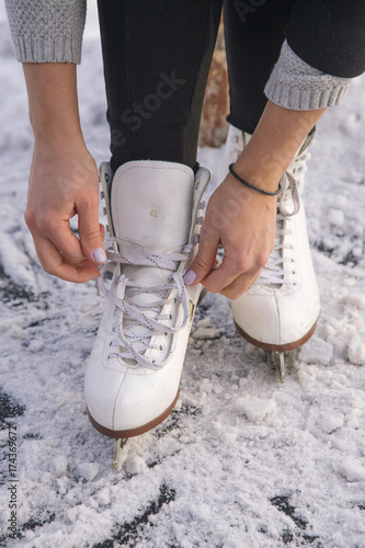 Close-up of woman's hands lacing her skates