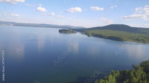 Aerial view of a remote tropical beach surrounded by forest. Aerial view of the lush Islands and lake. Flying Drone Above Beautiful Blue Sea Water. Wonderful Panoramic Landscape photo