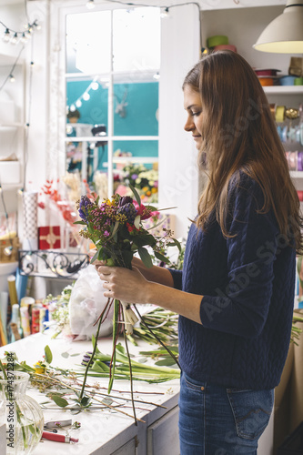 Close-up of woman arranging flowers