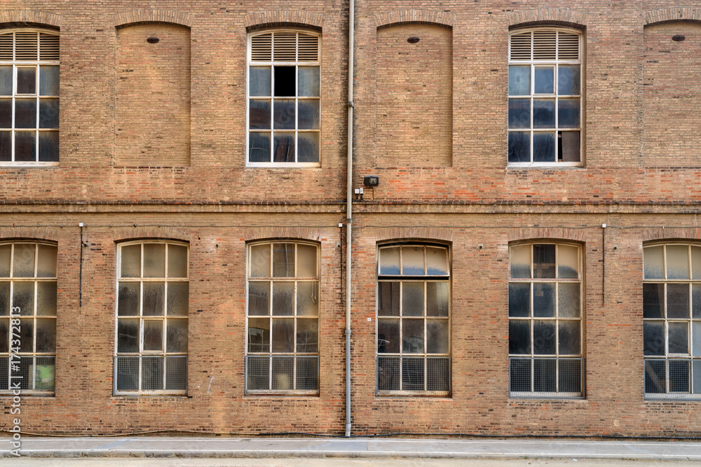 Frontal view of factory facade with a lot of windows Frontal view of factory facade with a lot of windows