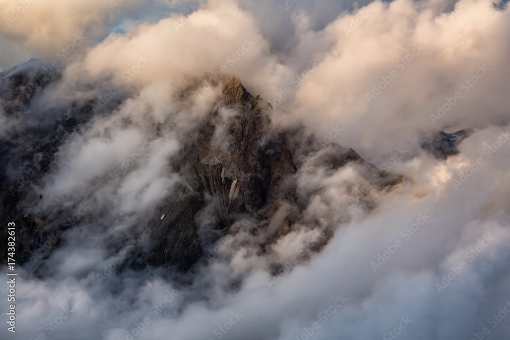 Beautiful artistic render of a rocky mountain peak covered by the clouds. Picture taken in Garibaldi, near Squamish, BC, Canada.