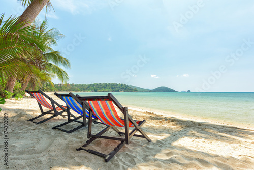 Beach chairs on the white sand beach and tropical sea