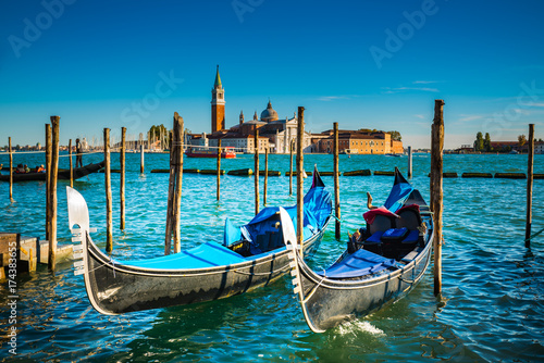 Gondolas floating on the Grand Canal with San Giorgio Maggiore Church in the background © takepicsforfun