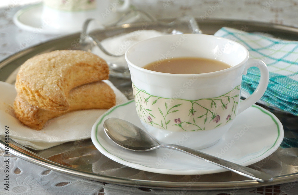 Biscuits and tea with milk on a tray Biscuits and tea with milk on a tray