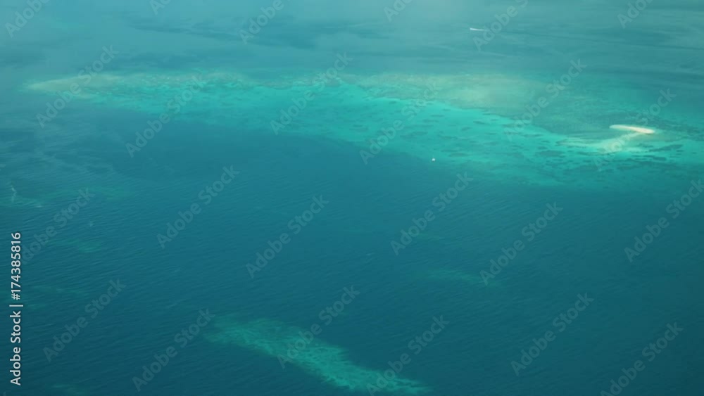An aerial shot of the deep and massive blue sea that shows corals in the water. An aerial shot of the deep and massive blue sea that shows corals in the water.