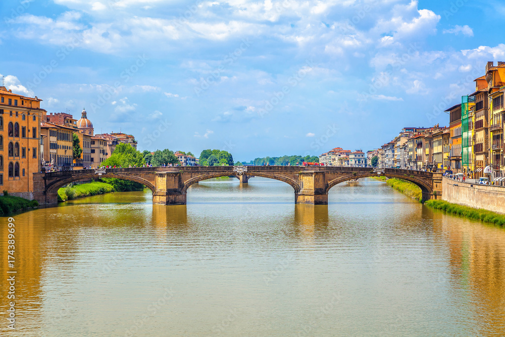 Florence. City landscape. In the foreground the old medieval arched bridge - Ponte Santa Trinita.