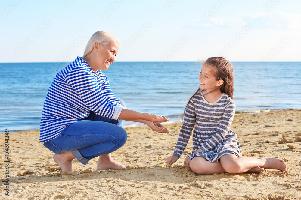 Cute girl with grandmother on sea beach Cute girl with grandmother on sea beach